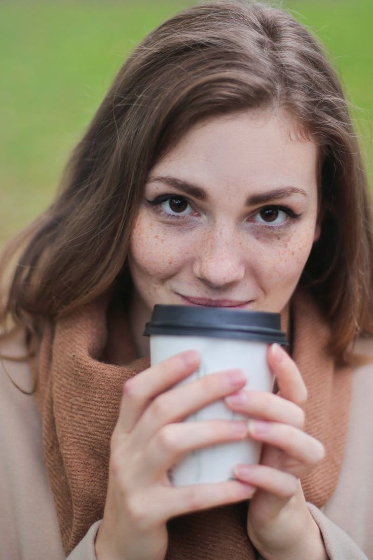 a woman holding a cup of coffee with the caption, coffee is a brew drink prepared from roasted coffee beans