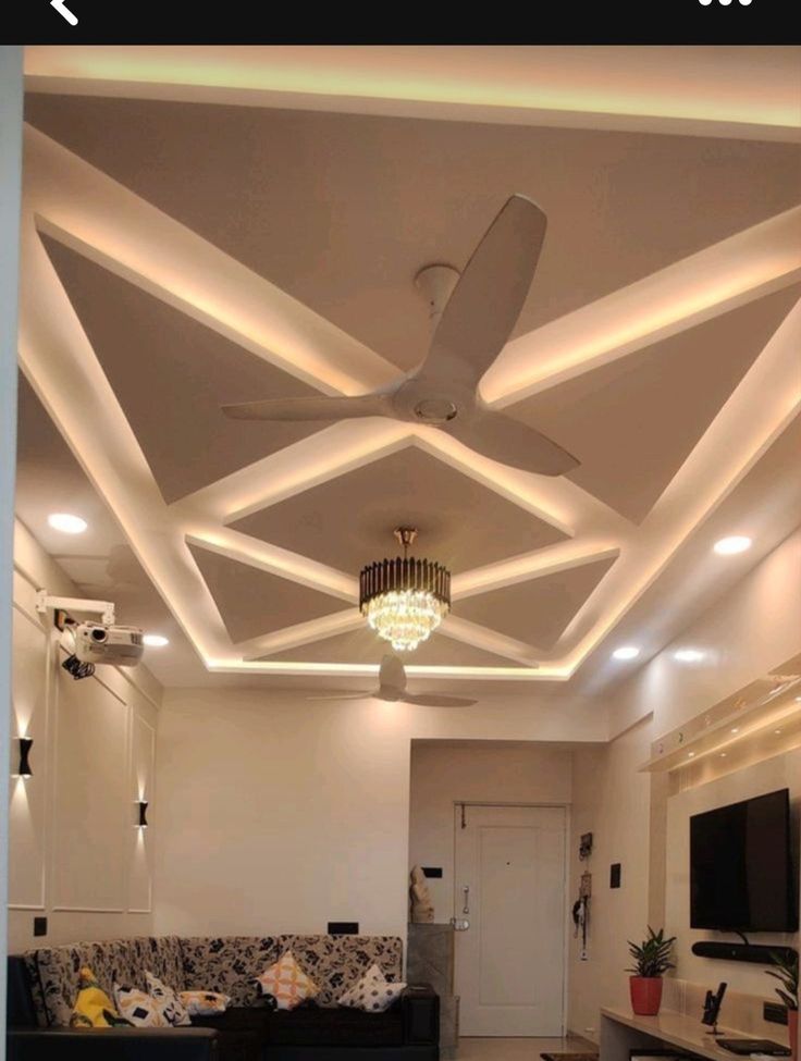 a living room filled with furniture and a ceiling fan