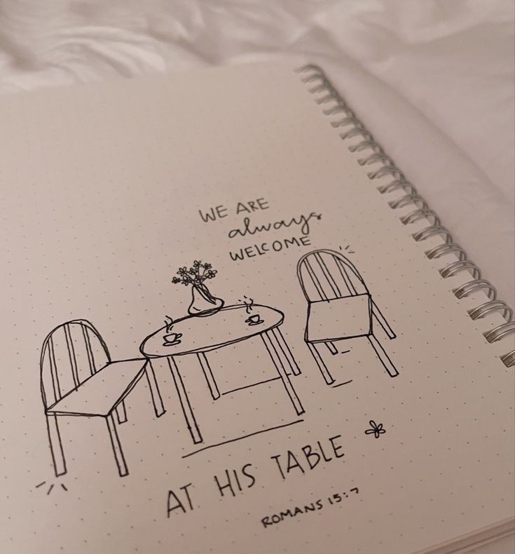 a notepad with a drawing of two chairs and a table on it that says, we are always welcome at his table