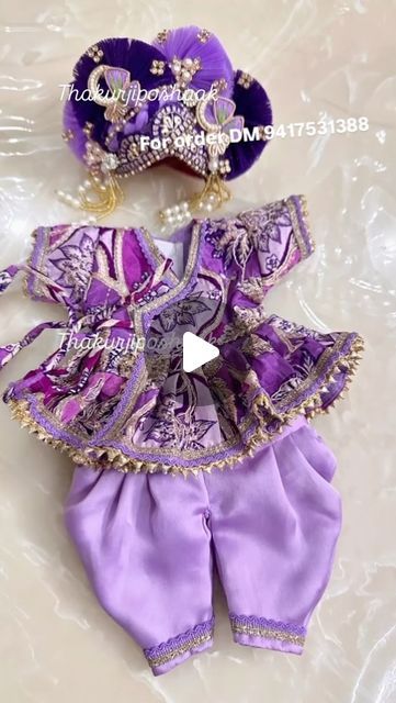 the doll is dressed in purple and gold