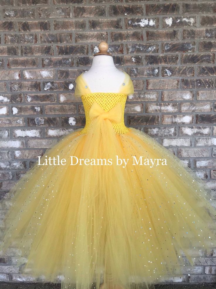 "Welcome to Little Dreams by Mayra This dress is absolutely adorable, very very puffy and sparkly! It has four layers of tulle that makes it very puffy and princess style, skirt is made with yellow tulle and sparkly yellow tulle. Straps of the dress are made with tulle, thus straps go to the back and you must tight them with a bow or knot, little gems are glued to the straps, very very pretty, I don't think pictures show how gorgeous this dress is! your little one will feel like a real princess Yellow Tulle Dress For Birthday, Yellow Ruffled Tutu Dress For Wedding, Yellow Tutu Dress For Birthday, Yellow Wedding Tutu Dress With Ruffles, Yellow Fitted Princess Tutu Dress, Cute Yellow Princess Dress For Party, Fitted Yellow Tutu Dress For Dress-up, Yellow Tulle Tutu Dress For Party, Cute Yellow Princess Party Dress