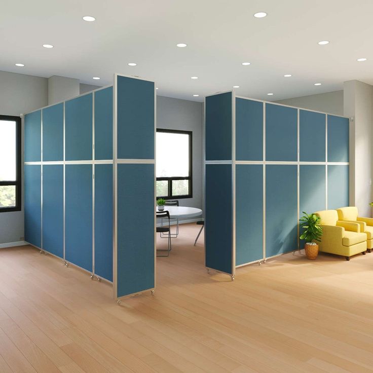 a room divider in the middle of a wood floored area with yellow chairs