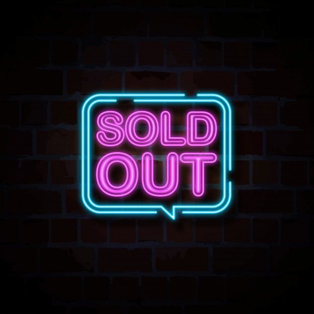 a neon sign that says sold out on a dark brick wall with the word sold out in