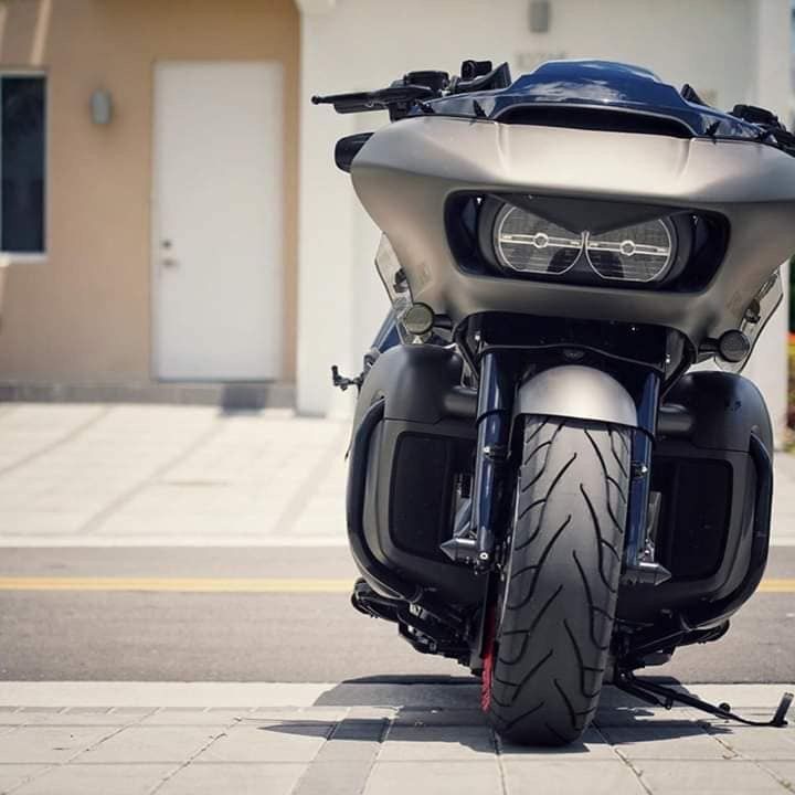 a motorcycle is parked on the side of the road in front of a building with a door