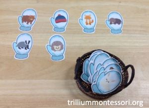 a basket filled with lots of blue stickers on top of a wooden table covered in animals