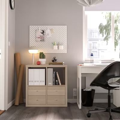 an office with a desk, chair and lamp in the corner by the window is empty