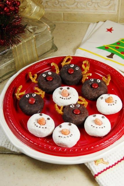 a red plate topped with snowmen covered in frosting on top of a table