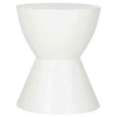 a white vase sitting on top of a table