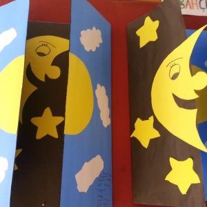 two paper bags with the moon and stars painted on them, one is blue and the other is yellow