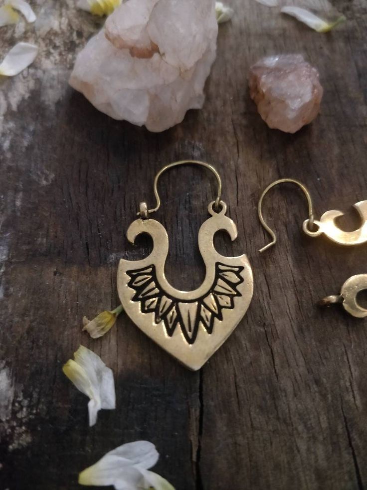 Elevate your boho style game with these stunning Tribal Danglers. Handmade with love and attention to detail, these earrings feature a gorgeous vintage boho design that is sure to set you apart from the crowd. Made with high-quality brass, these earrings offer both durability and unique charm. Whether you're dressing up for a casual evening or a romantic date night, these earrings are the perfect accessory to complete your look. Don't miss your chance to add these beautiful and one-of-a-kind earrings to your collection. Order now and embrace the beauty of bohemian style with our Tribal Danglers. Bohemian Dangle Brass Jewelry, Bohemian Brass Dangle Jewelry, Artisan Chandelier Earrings For Festival, Artisan Style Chandelier Earrings For Festival, Artisan Festival Chandelier Earrings, Bronze Dangle Earrings For Festivals, Bohemian Chandelier Earrings With Ear Wire For Festivals, Bohemian Chandelier Earrings For Pierced Ears, Bohemian Teardrop Jewelry With Ear Wire