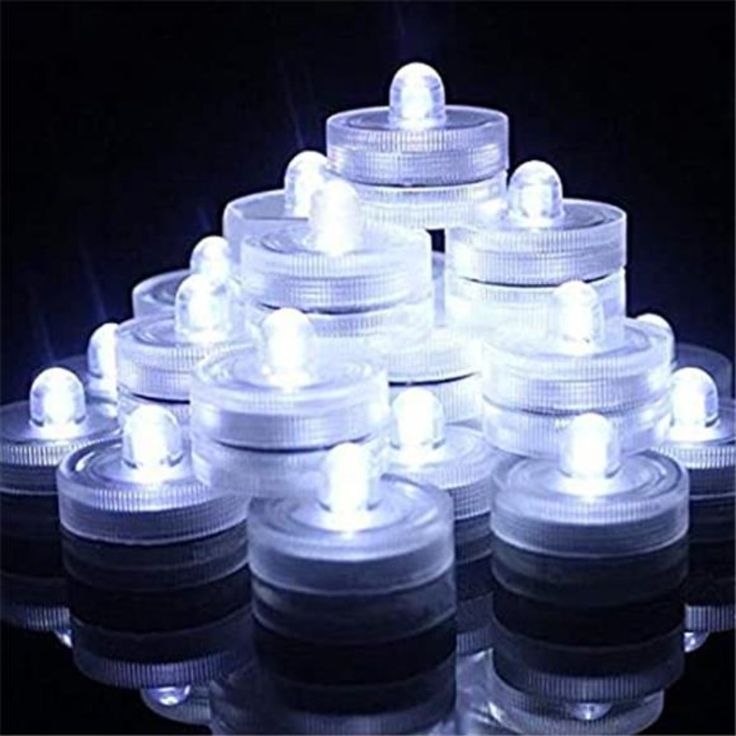 a group of white lights sitting on top of each other in front of a black background