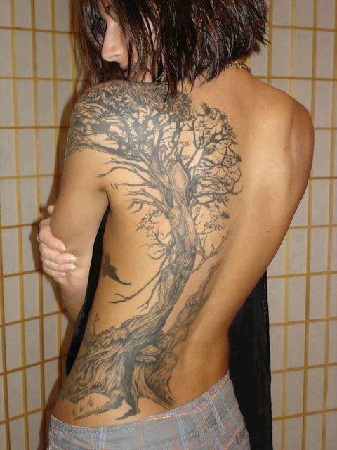 a woman with a tree tattoo on her back