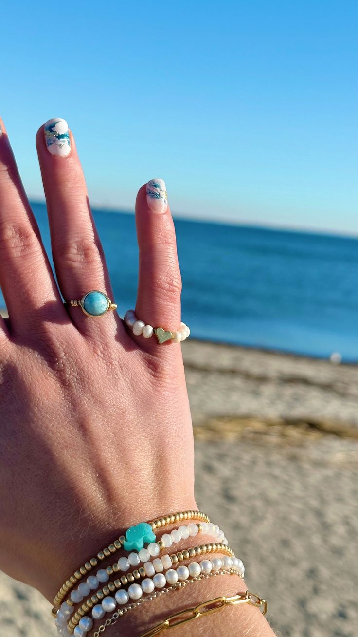 Stunning turquoise and white crackled 7mm Larimar gemstone bead hand-wrapped in gold or silver wire. Ocean Tides, Dainty Chain Necklace, Gem Ring, Wire Wrapped Rings, Turquoise Stones, Glass Beaded Bracelets, Seed Bead Bracelets, In The Ocean, Stunning Necklace