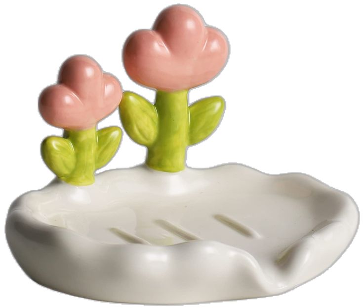 two pink flowers sitting on top of a white plate