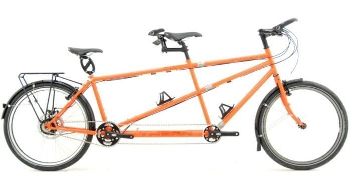 an orange bicycle is shown against a white background