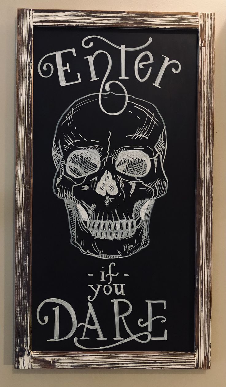 a chalkboard with a skull on it that says enter if you dare