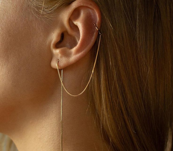 Introducing our Gold Cuff Chain Earrings, the perfect accessory for those who love a touch of elegance and minimalism. Crafted with care, these ear cuffs feature a stunning gold plated 14K finish that exudes a radiant glow. No piercing required - these cuffs simply slide onto your earlobe, adding a unique and stylish charm. With a delicate and versatile chain design, they effortlessly thread through your ear, enhancing your look with a subtle and sophisticated touch. Perfect for everyday wear or Minimalist Pierced Yellow Gold Ear Cuff, Elegant Everyday Cartilage Earrings With Adjustable Chain, Gold Minimalist Ear Cuff With Adjustable Chain, Minimalist Dangle Ear Cuff For Everyday, Minimalist Everyday Dangle Ear Cuff, Minimalist Tarnish Resistant Ear Climbers For Everyday, Everyday Minimalist Dangle Ear Cuff, Everyday Minimalist 14k Gold Ear Cuff, Waterfall Jewelry