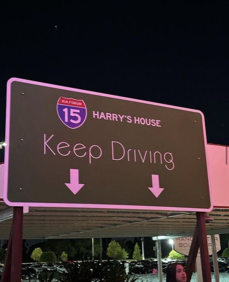 a sign that says harry's house keep driving