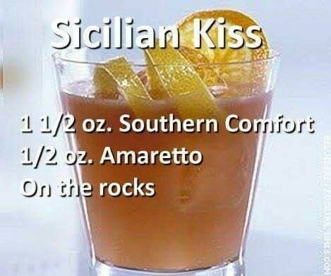 an orange drink in a glass with the words sicilian kiss on it