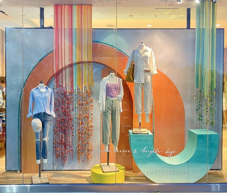 a window display with mannequins and clothing