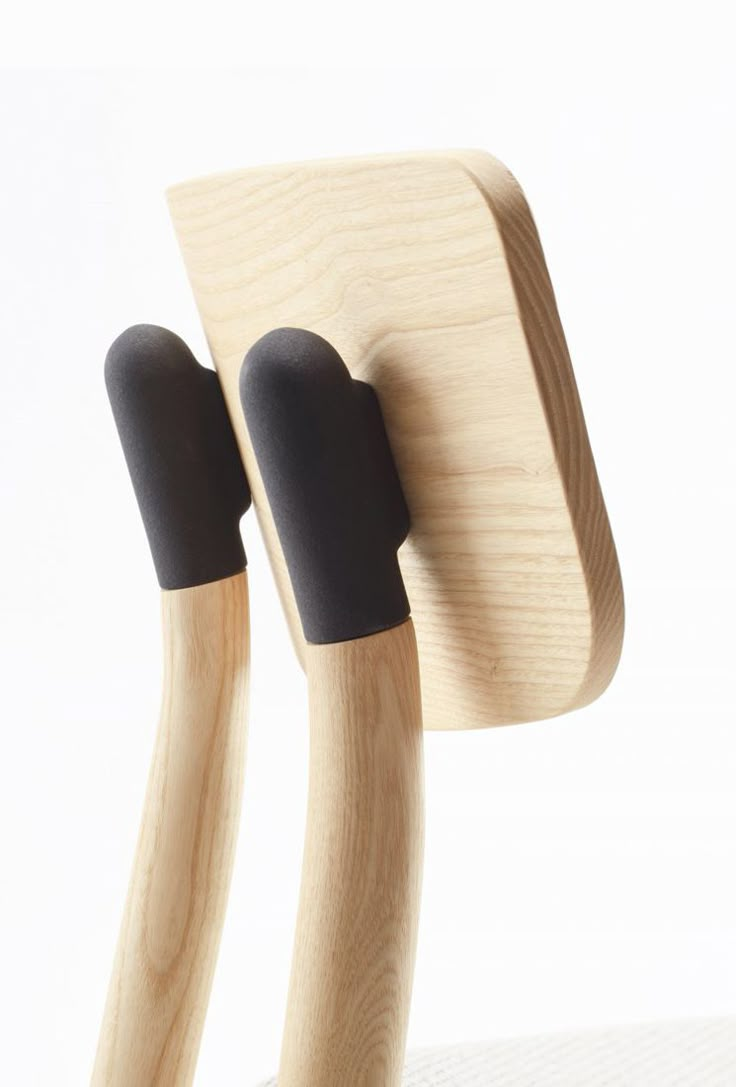 two black handles on the back of a wooden chair