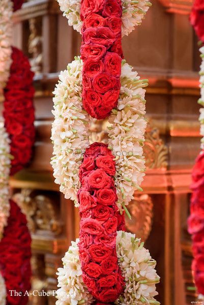 red and white flowers are hanging from the ceiling