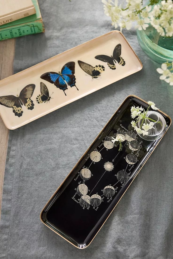 two trays with flowers and butterflies on them