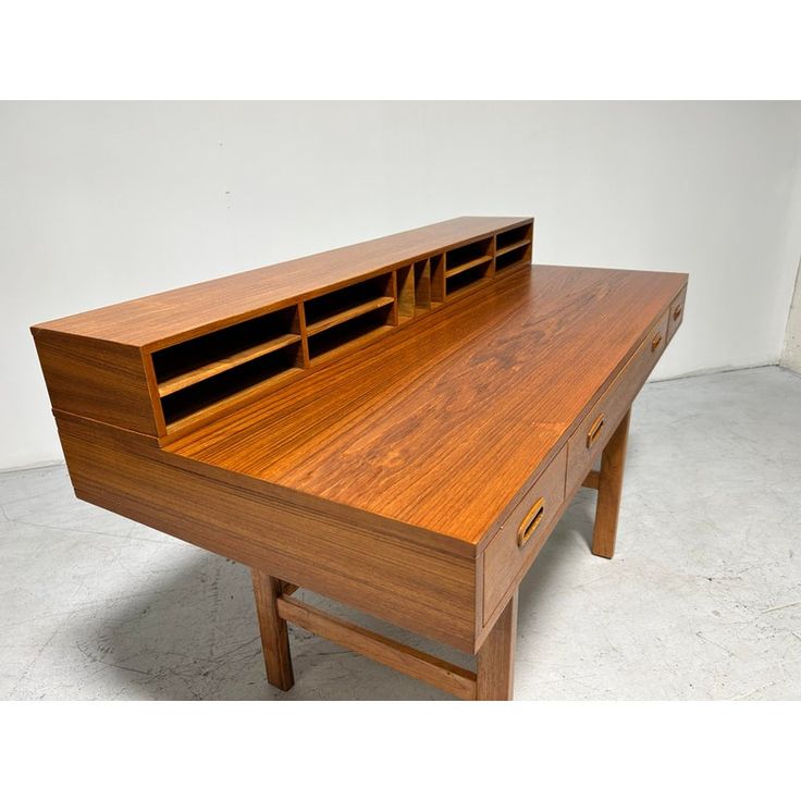 a wooden desk with two drawers on each side and an open drawer at the top