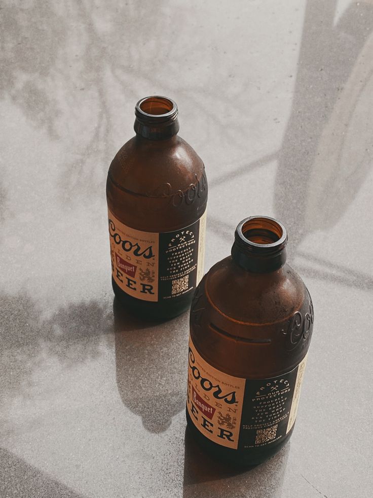 two brown bottles sitting on top of a table