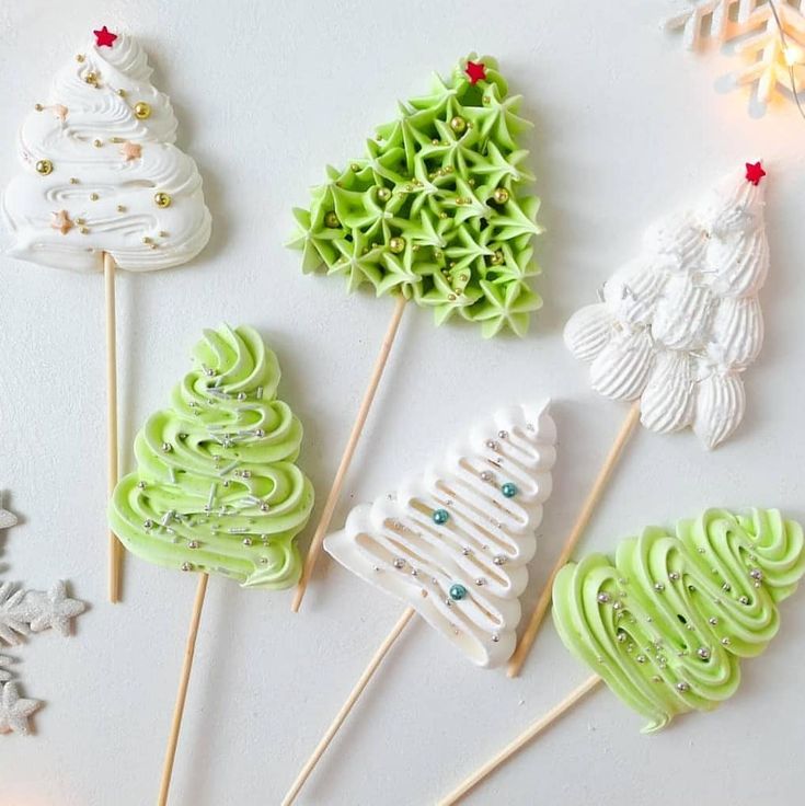 some green and white christmas trees on sticks