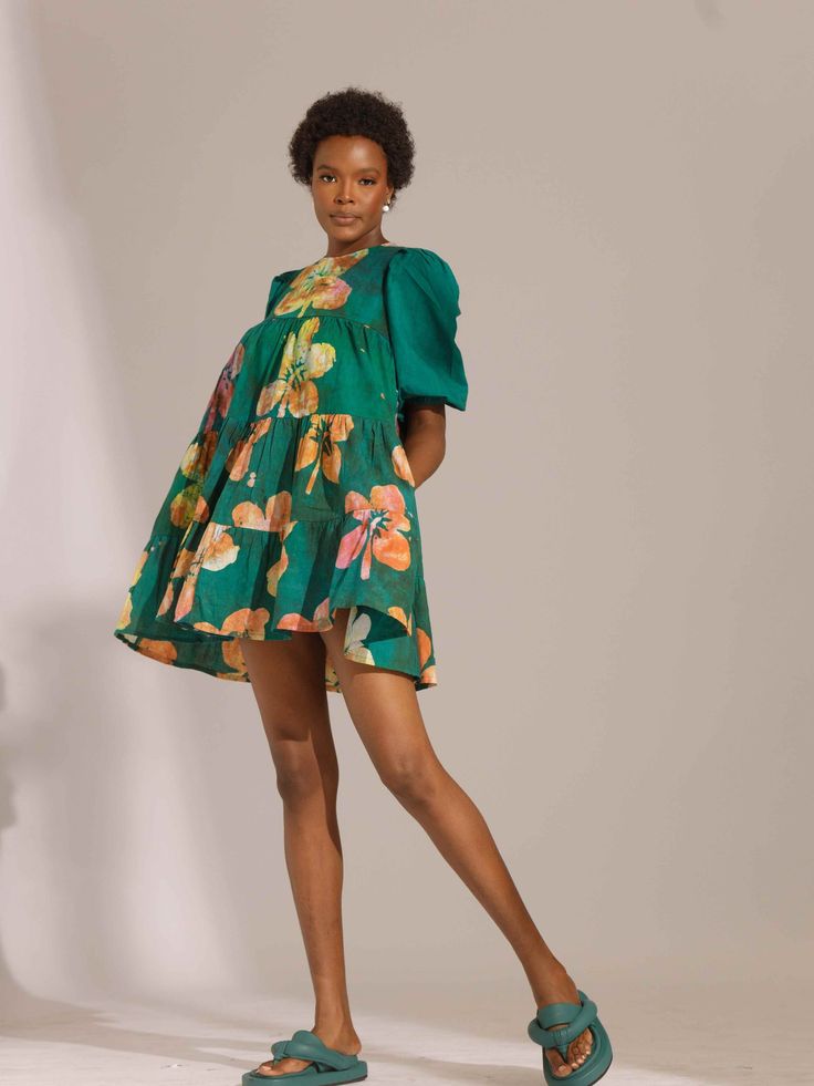 Simi mini dress features a tiered silhouette, made in a super blush, soft African print cotton fabric. Short sleeves On-seam pockets Single button closure 100% cotton Hand wash Fit: True to size As with all our products, every purchase allows us to continue to further our mission of supporting our Artisans with Jobs and economic empowerment. Pattern placement might vary from pictured. Cotton Mini Tiered Dress For Brunch, Cotton Mini Length Tiered Dress For Day Out, Cotton Mini Length Tiered Dress For Brunch, Cotton Tiered Mini Dress, Mini Length Cotton Tiered Dress For Spring, Cotton Tiered Dresses With Floral Print, Cotton Mini Dress With Tiered Skirt For Day Out, Cotton Tiered Skirt Mini Dress For Day Out, Tiered Cotton Dress With Floral Print