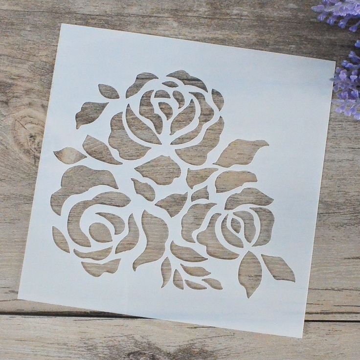 a piece of paper with cut out flowers on it next to some lavenders and a purple flower