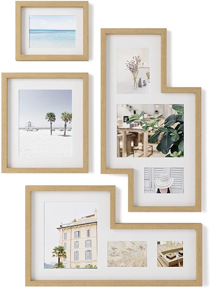 three wooden frames hanging on the wall with pictures and plants in them, one has a beach scene