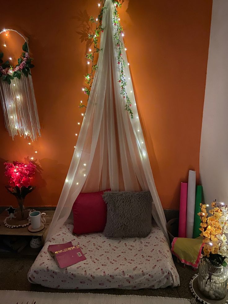 a bed with a white canopy over it in a room filled with books and decorations