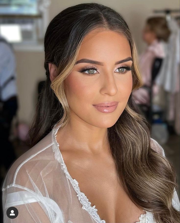 a woman with long hair wearing a sheer top