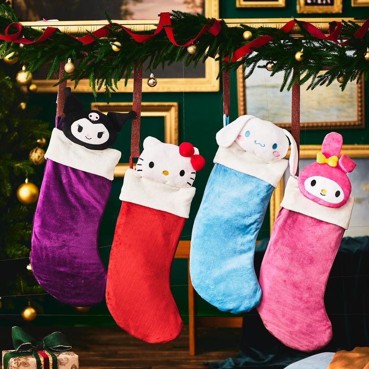 three stockings with hello kitty designs hanging from a christmas tree