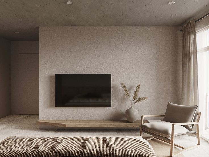 a large flat screen tv mounted to the side of a wall in a living room