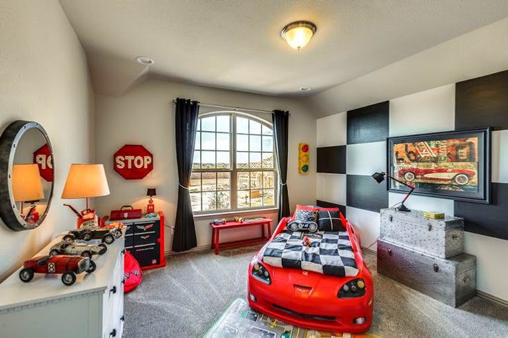 a bedroom with a red car bed and checkered walls