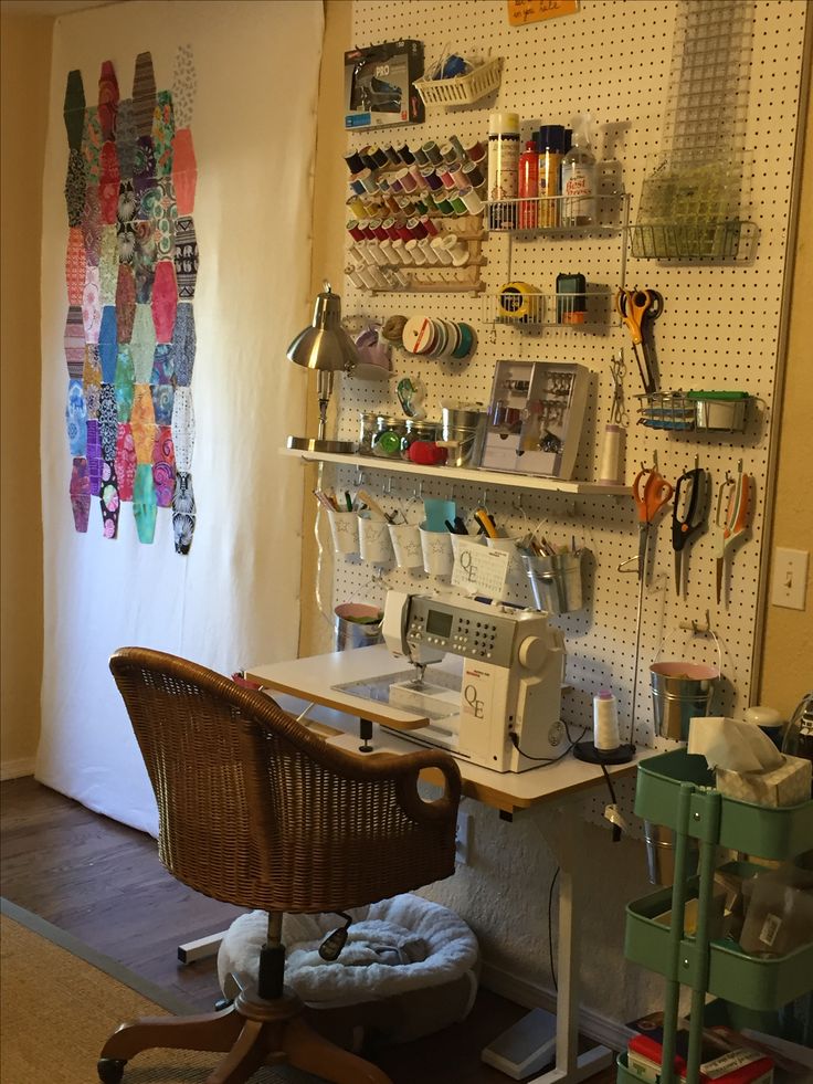 a sewing machine sitting on top of a wooden chair in front of a wall mounted shelf