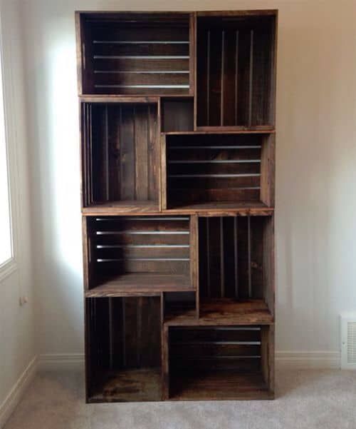 a wooden bookcase sitting on top of a carpeted floor next to a window