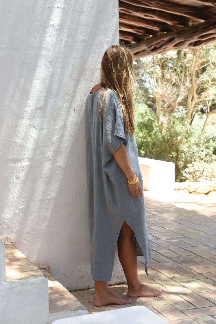 Style // The ultimate stormy blue kaftan is perfect for any occasion When comfort meets style, the Cala Kaftan features a billowy, shapeless silhouette and mid-length. With a v-neck silhouette, wide sleeves and two side slits, it promises to be your go-to look for that cozy, effortless look. The lightweight linen-cotton blend fabric is extra soft, to ensure you won't ever want to take it off Fabric Note // Made in Italy from a Linen & Cotton blend Sizing Advice // Available in one size, for an o Casual V-neck Kaftan For Daywear, Blue Relaxed Fit V-neck Tunic, Casual V-neck Relaxed Fit Kaftan, V-neck Tunic For Daywear With Relaxed Fit, Relaxed Fit V-neck Tunic For Daywear, Blue Oversized Kaftan For Loungewear, Blue V-neck Kaftan For Loungewear, Oversized Blue Kaftan For Loungewear, Relaxed Fit V-neck Tunic For Loungewear