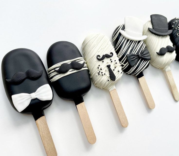 there are six pops decorated with different types of food on sticks in the shape of mustaches and hats