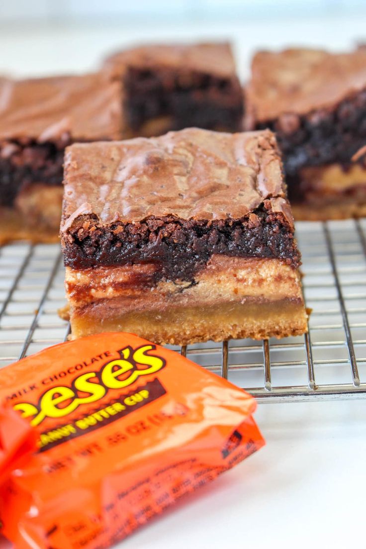 some brownies are cooling on a rack with a bag of reese's candy