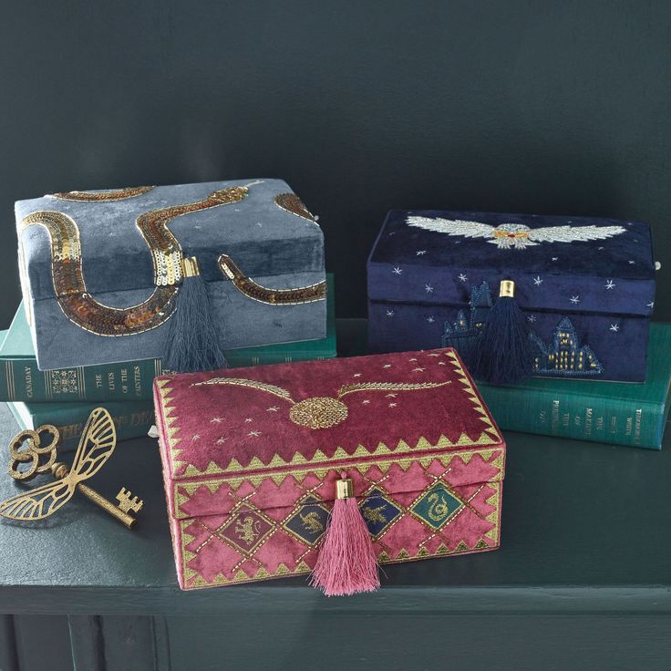 three different types of purses sitting on top of a table next to each other