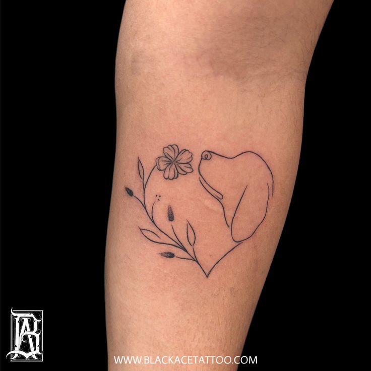 an elephant and flower tattoo on the leg