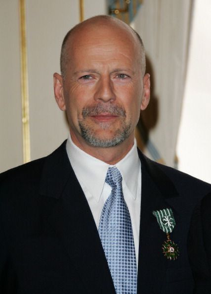 a bald man wearing a suit and tie