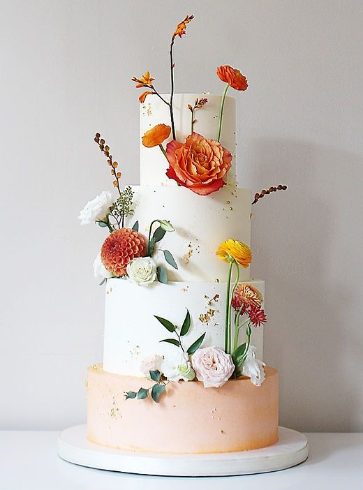 a three tiered cake with flowers on it