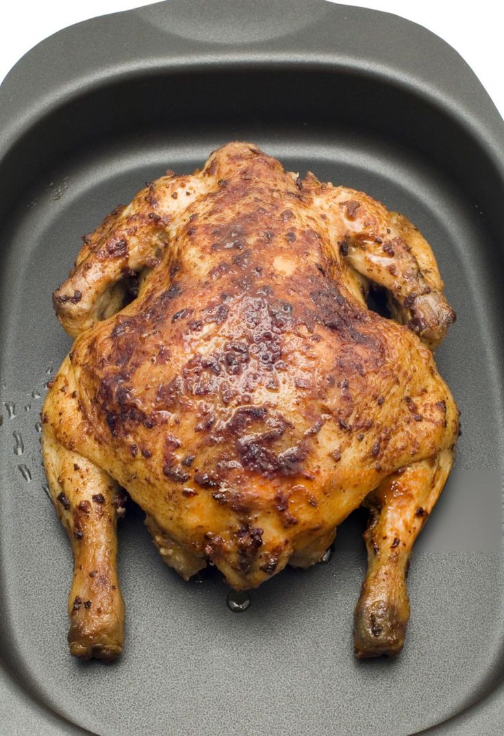 a cooked chicken sitting on top of a pan