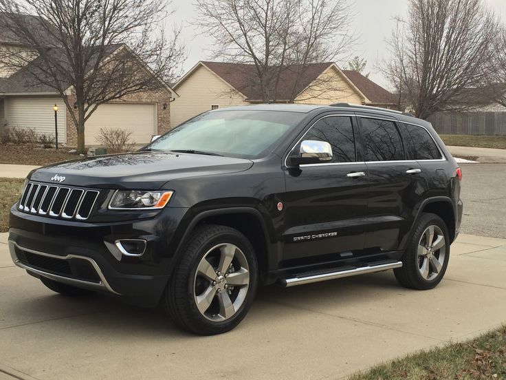 a black jeep parked in front of a house