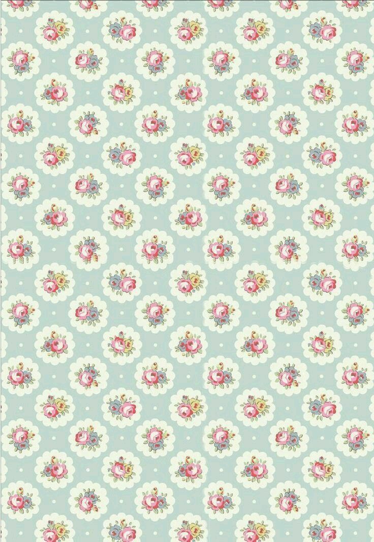 a blue and white wallpaper with pink flowers on it